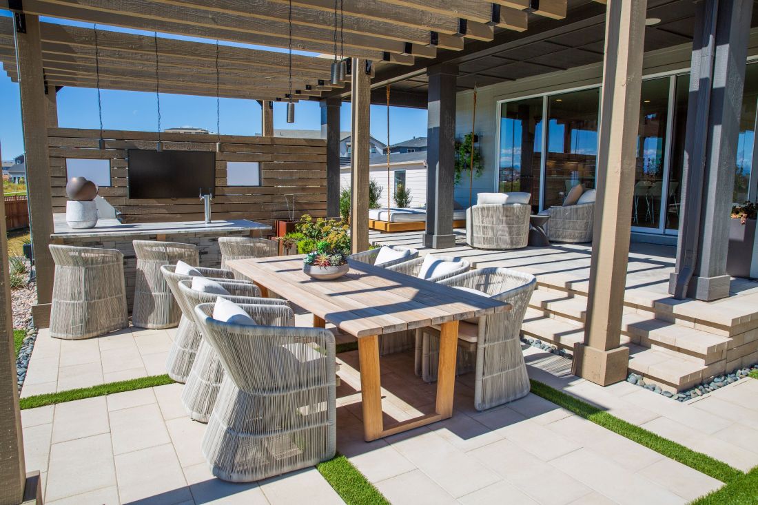 Covered Denver outdoor living area with dining space, kitchen and pergola