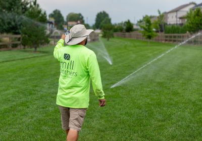 Mill Brothers irrigation technician inspecting sprinkler coverage for an HOA landscape