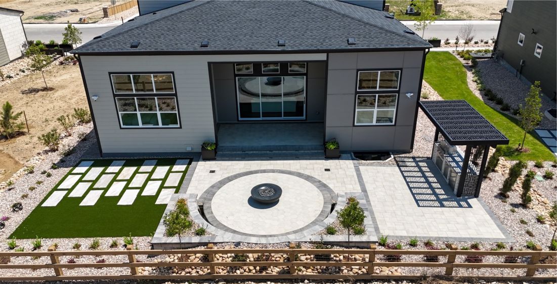 Aerial view of a modern Denver backyard with paver patio, fire pit and pergola